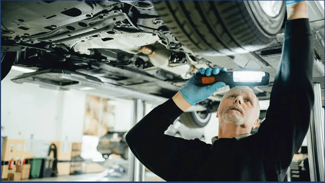 Technician servicing a vehicle